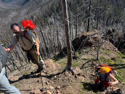 The group navigates a very steep trail